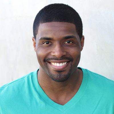 An elderly couple posing together with smiles on their faces, embracing each other for a photo.